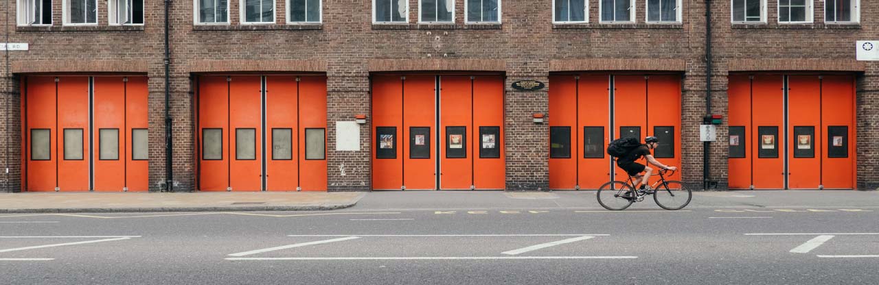 photo of fire station doors with cyclist passing